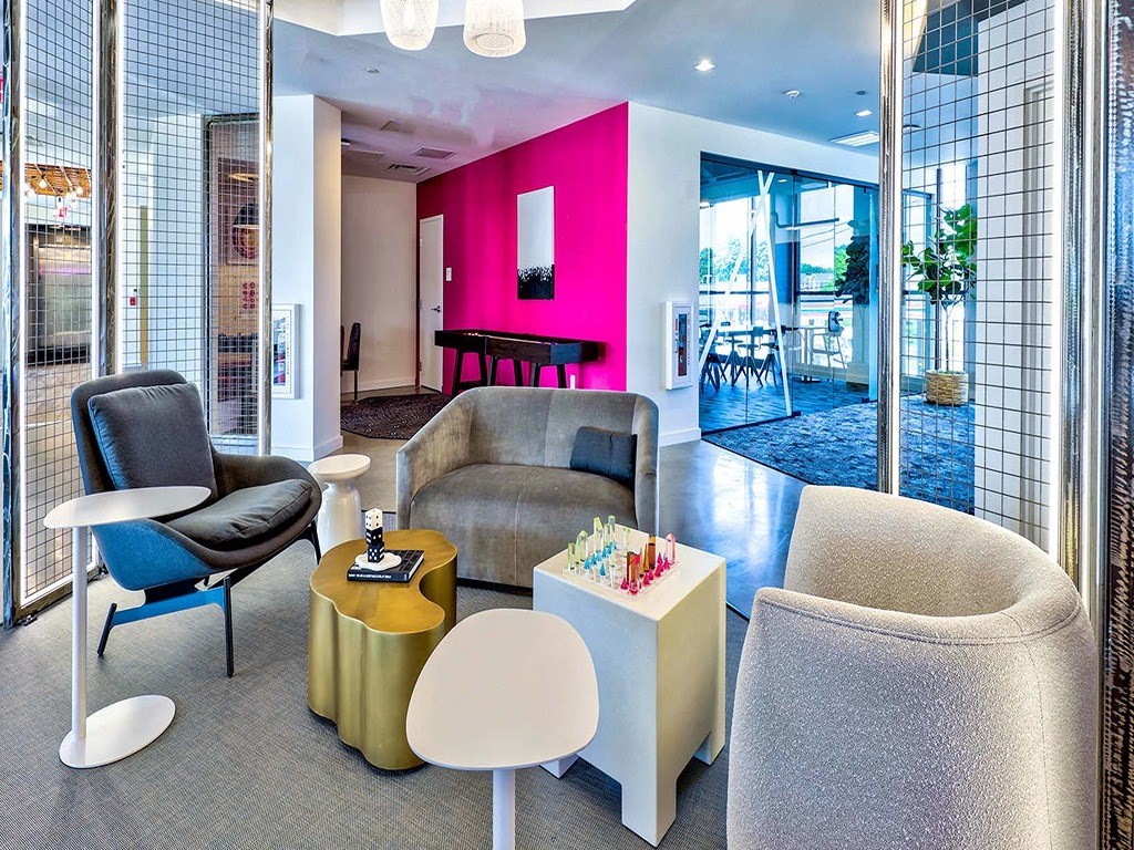 a living room with a couch and chairs and a table